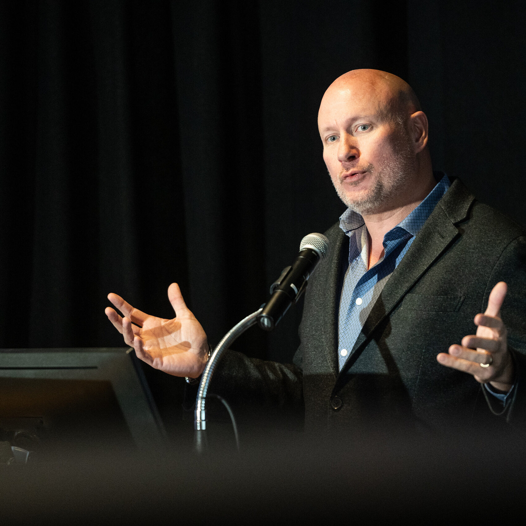 Commissioner O'Keefe speaking into a microphone