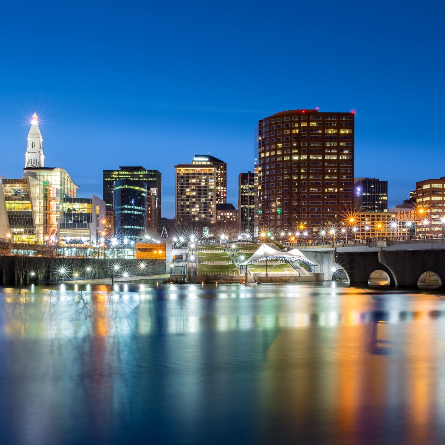 Hartford skyline and Founders Bridge at dusk. Hartford is the capital of Connecticut.