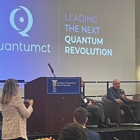 woman speaking at QuantumCT conference