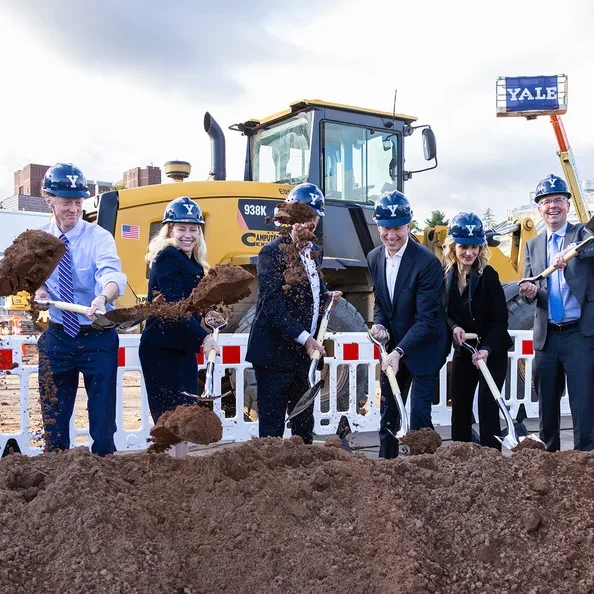 alt="Scott Strobel, Justin Elicker, Maurie McInnis, Ned Lamont, and others throwing dirt with shovels"